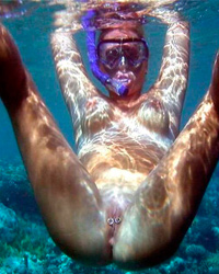 A busty bikini slut undressing on the Cap d'Agde Image 2