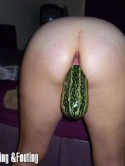 Fucking a girl with a squash in her ass
